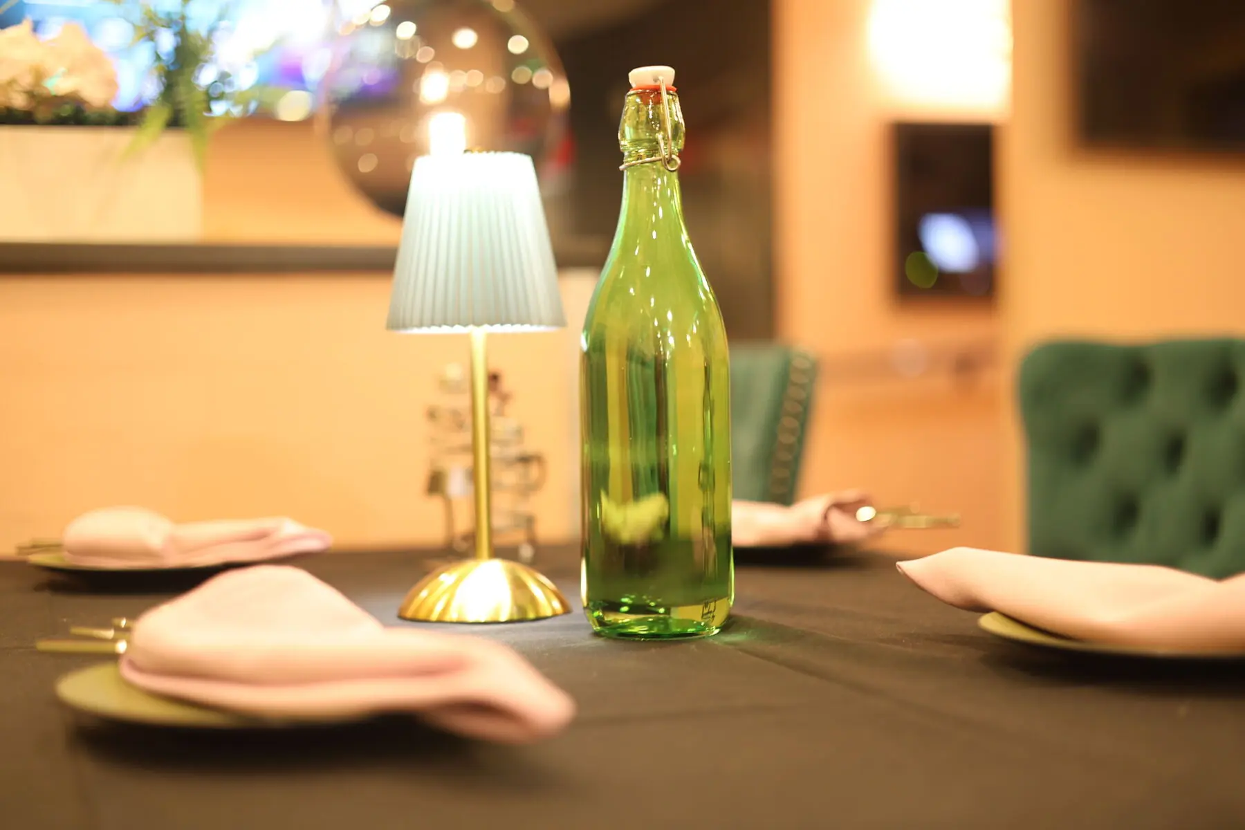 Table detail with candlelight and glass bottle